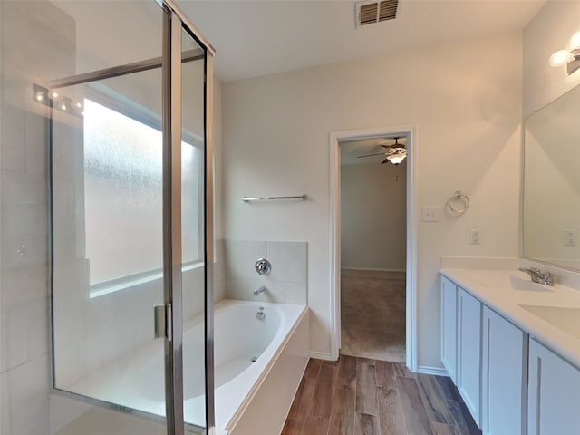 full bathroom featuring wood finished floors, visible vents, a stall shower, a sink, and a bath