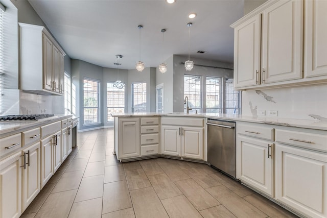 kitchen with a sink, dishwasher, a peninsula, and a healthy amount of sunlight