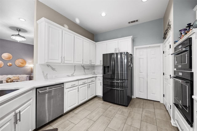 kitchen featuring recessed lighting, visible vents, white cabinets, and stainless steel appliances