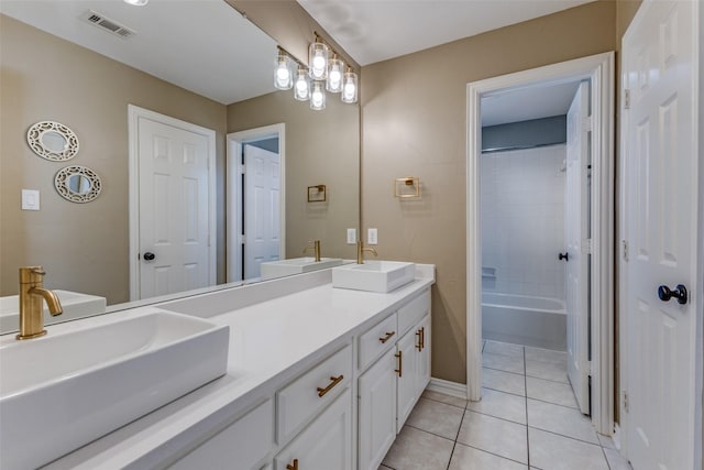 bathroom featuring a sink, visible vents, double vanity, and tile patterned flooring