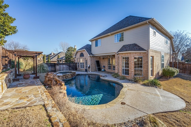 view of swimming pool featuring a patio area, a pool with connected hot tub, a pergola, and a fenced backyard