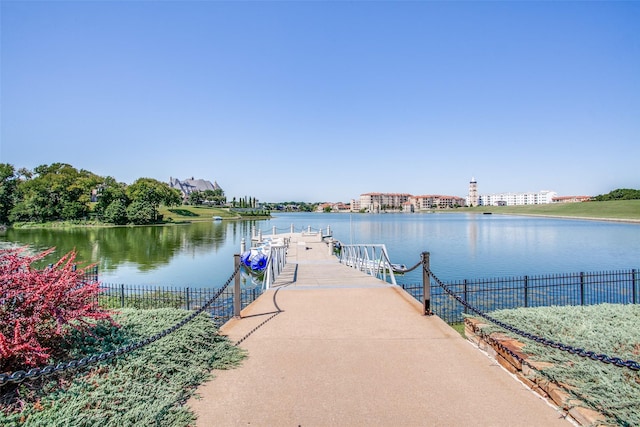 exterior space featuring a water view and fence