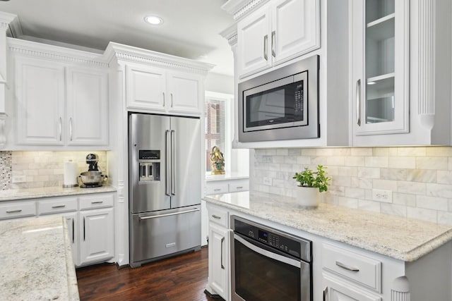 kitchen with white cabinets, stainless steel appliances, and dark wood-type flooring