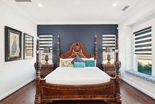 bedroom with visible vents, multiple windows, baseboards, and hardwood / wood-style flooring