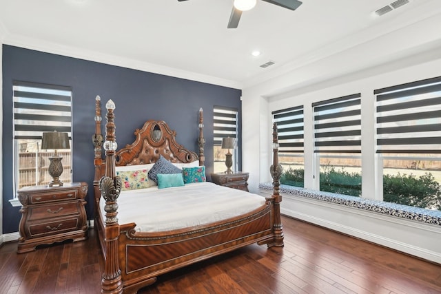 bedroom featuring crown molding, baseboards, visible vents, and wood-type flooring