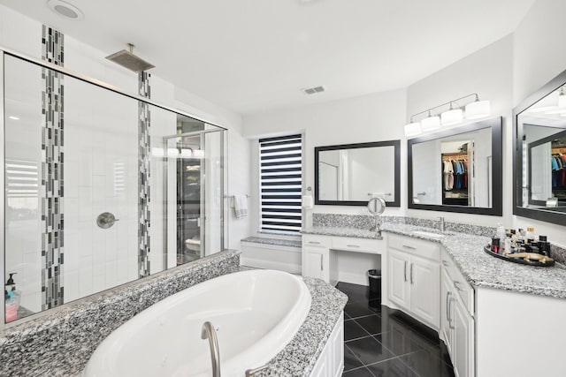 bathroom with visible vents, a shower stall, a garden tub, tile patterned floors, and vanity