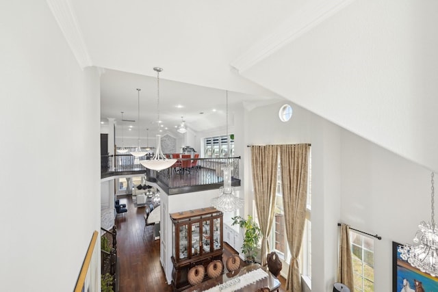 interior space featuring a chandelier, vaulted ceiling, crown molding, and hardwood / wood-style floors