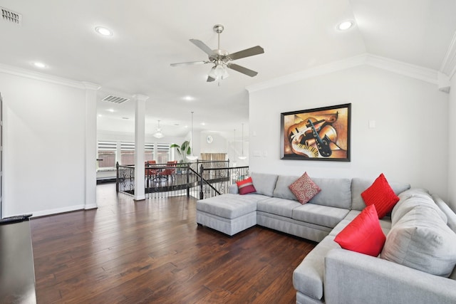 living area featuring visible vents, wood finished floors, decorative columns, and ornamental molding