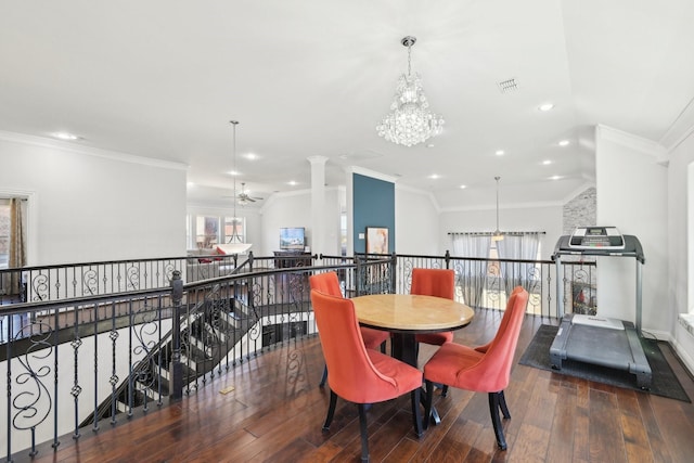 dining room featuring hardwood / wood-style floors, decorative columns, recessed lighting, ornamental molding, and ceiling fan with notable chandelier