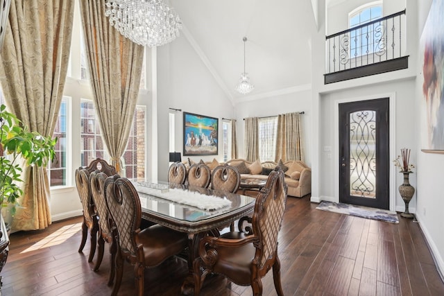 dining room with dark wood-type flooring, plenty of natural light, and a chandelier