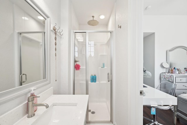 full bathroom featuring a stall shower and vanity