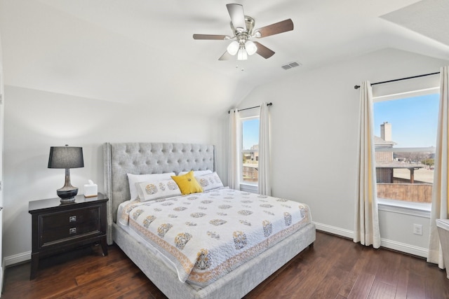 bedroom with visible vents, multiple windows, dark wood-style floors, and vaulted ceiling