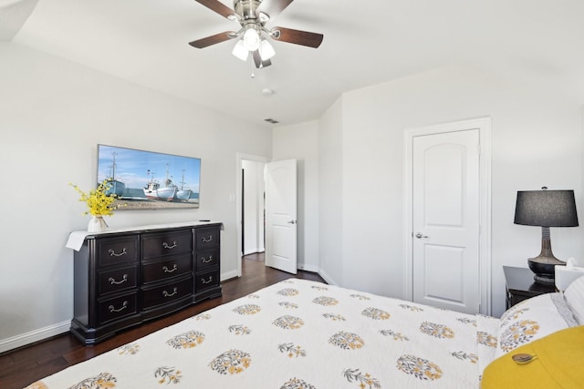 bedroom featuring dark wood finished floors, visible vents, baseboards, and ceiling fan