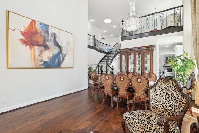 interior space with crown molding, baseboards, stairs, a towering ceiling, and hardwood / wood-style flooring