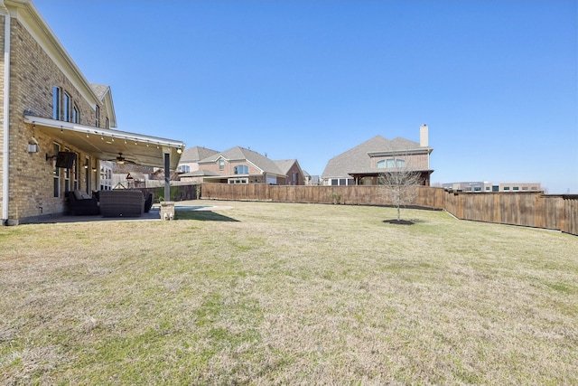 view of yard featuring a patio, a ceiling fan, and a fenced backyard