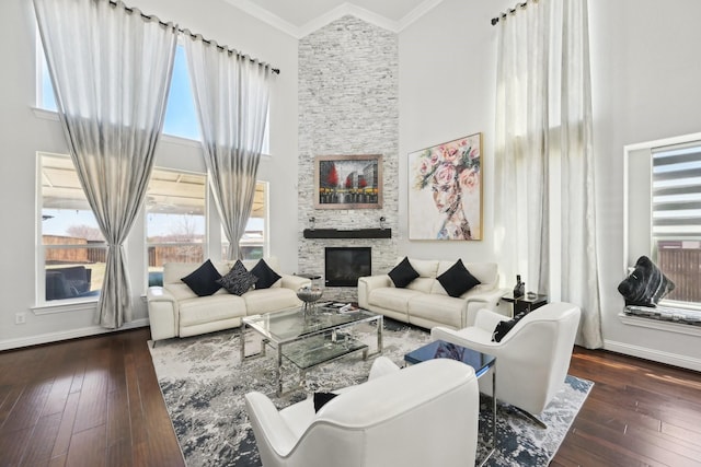 living room with a wealth of natural light, hardwood / wood-style floors, and crown molding