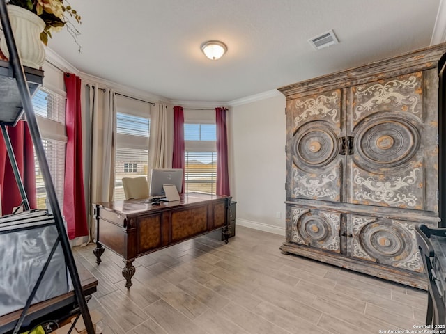 home office with wood finish floors, visible vents, baseboards, and crown molding