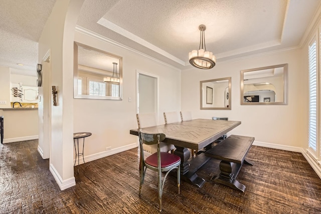 dining room featuring dark wood-type flooring, baseboards, a tray ceiling, an inviting chandelier, and a textured ceiling