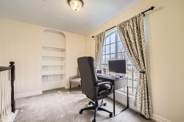 office area with baseboards, carpet, and a textured ceiling