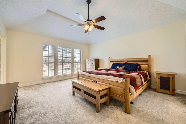 carpeted bedroom featuring baseboards, a textured ceiling, a ceiling fan, and vaulted ceiling