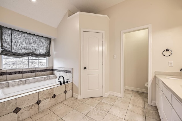 bathroom with vanity, a garden tub, vaulted ceiling, tile patterned floors, and toilet