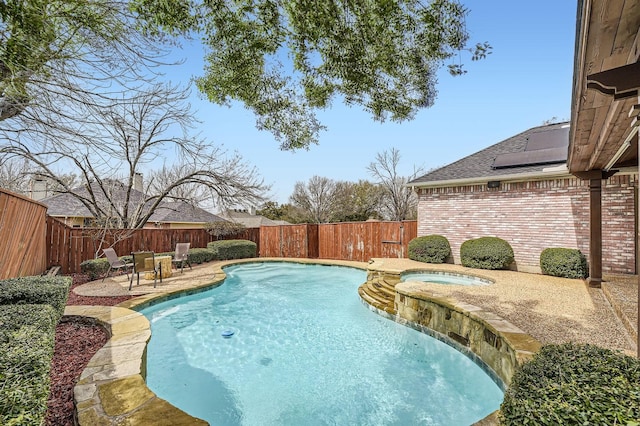 view of pool featuring a pool with connected hot tub, a fenced backyard, and a patio area