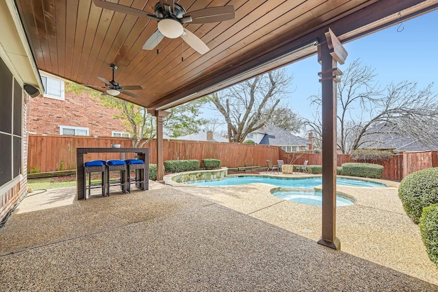 view of swimming pool with a fenced in pool, a patio, an in ground hot tub, and a fenced backyard