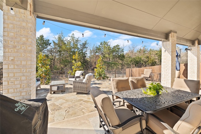 view of patio / terrace featuring a fenced backyard, an outdoor hangout area, and outdoor dining space