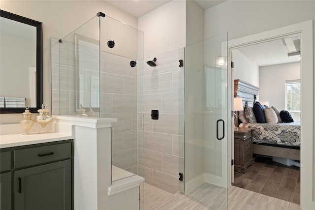 bathroom featuring vanity, a stall shower, and ensuite bathroom