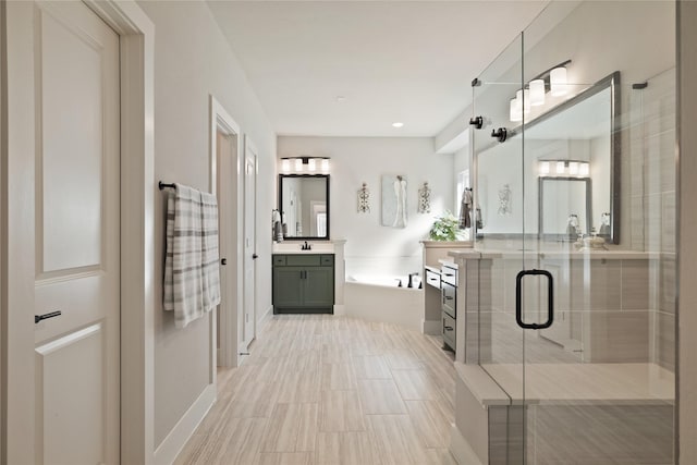 full bathroom featuring vanity, a bath, and a stall shower