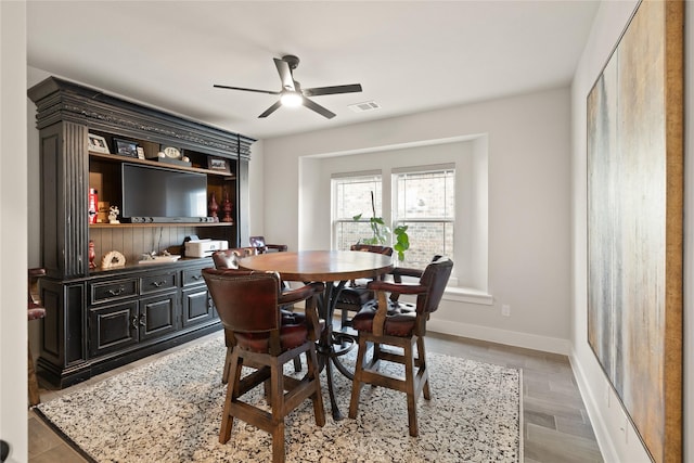 dining room featuring visible vents, baseboards, and ceiling fan