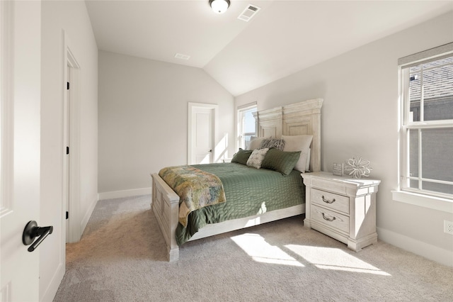 bedroom featuring lofted ceiling, light colored carpet, visible vents, and baseboards