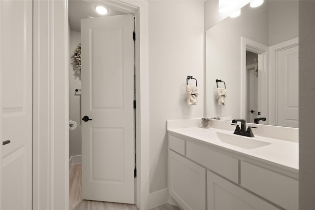 bathroom with vanity and baseboards