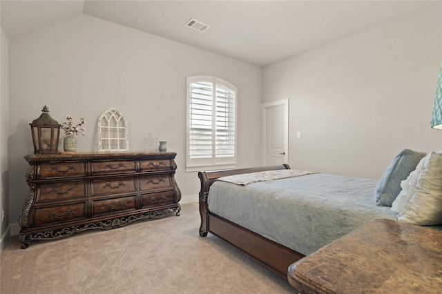 bedroom featuring vaulted ceiling, visible vents, and light carpet