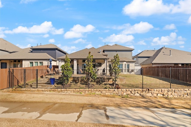 view of front facade with a patio area and a fenced backyard