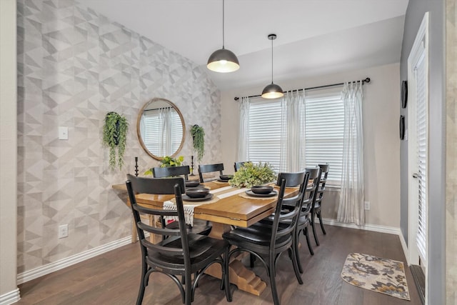 dining area with baseboards, wood finished floors, vaulted ceiling, and wallpapered walls