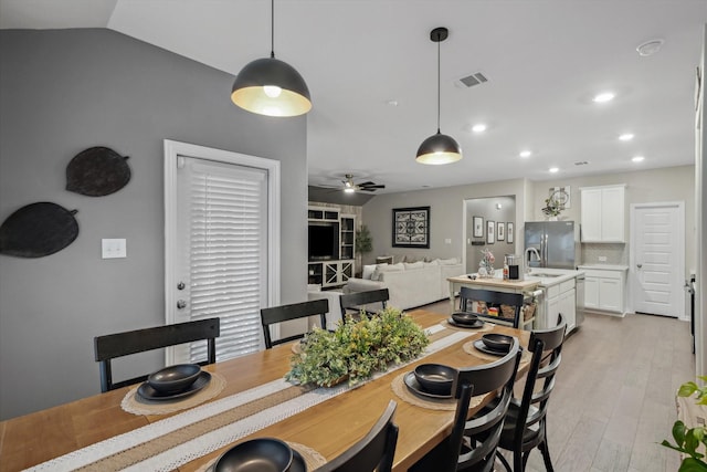 dining area with visible vents, ceiling fan, vaulted ceiling, recessed lighting, and light wood-style floors