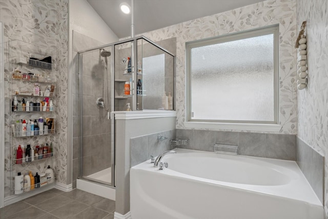 bathroom with tile patterned flooring, a garden tub, a stall shower, and wallpapered walls