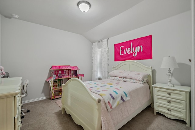 carpeted bedroom featuring vaulted ceiling and baseboards