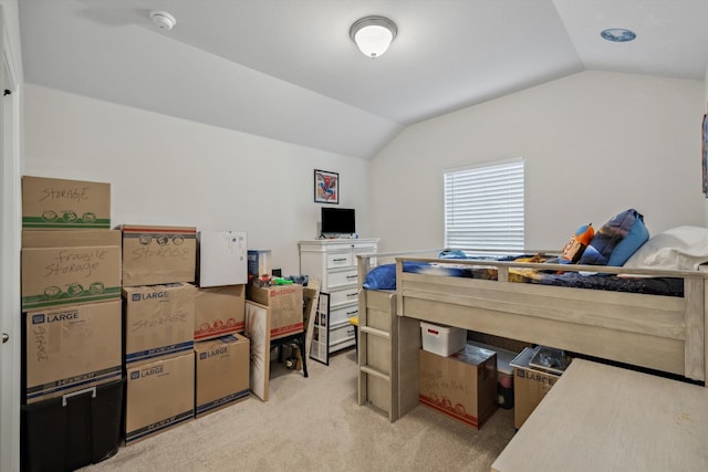 bedroom with vaulted ceiling and light carpet