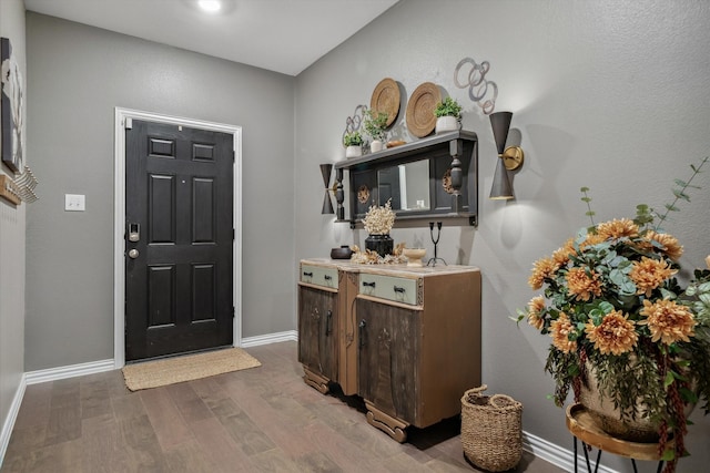 entrance foyer featuring baseboards and wood finished floors