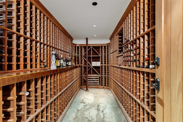 wine cellar with recessed lighting and unfinished concrete flooring