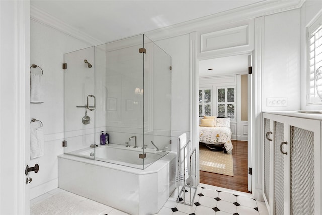 ensuite bathroom with a wainscoted wall, ensuite bathroom, crown molding, a decorative wall, and tile patterned floors