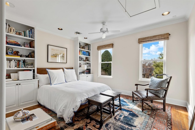 bedroom with visible vents, ornamental molding, wood finished floors, recessed lighting, and baseboards