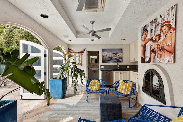 view of patio with ceiling fan, visible vents, and a sink