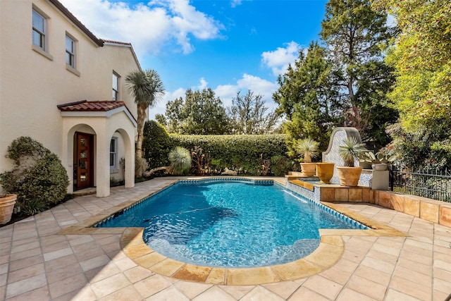 view of swimming pool featuring a patio area, a fenced in pool, and fence