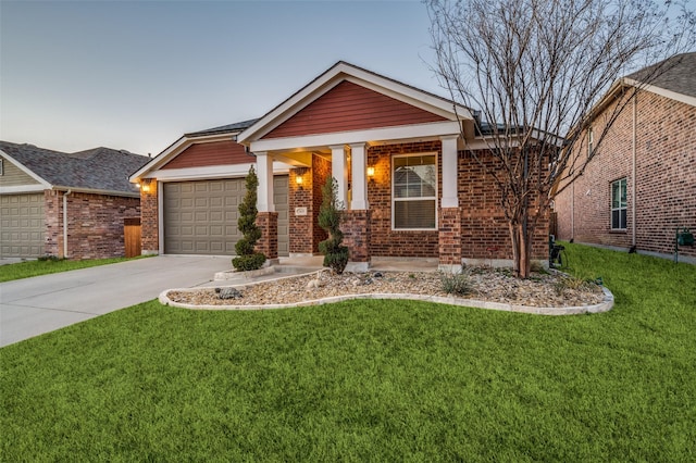 craftsman house with brick siding, driveway, and a front yard