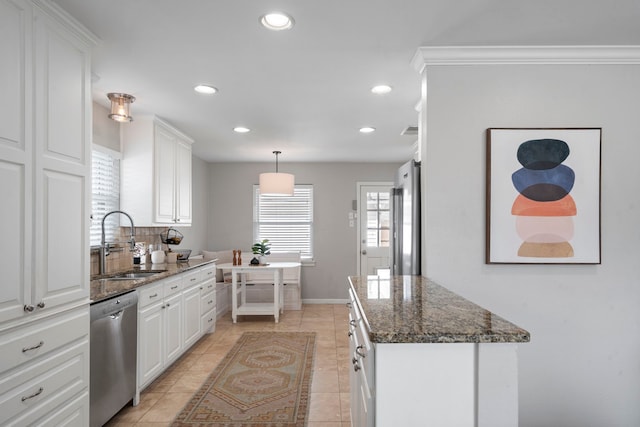 kitchen featuring a sink, white cabinetry, recessed lighting, dark stone counters, and appliances with stainless steel finishes