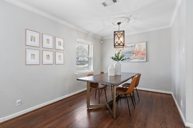 dining space featuring dark wood-style floors, visible vents, and baseboards