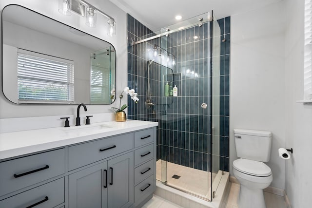 full bathroom featuring a stall shower, toilet, and vanity